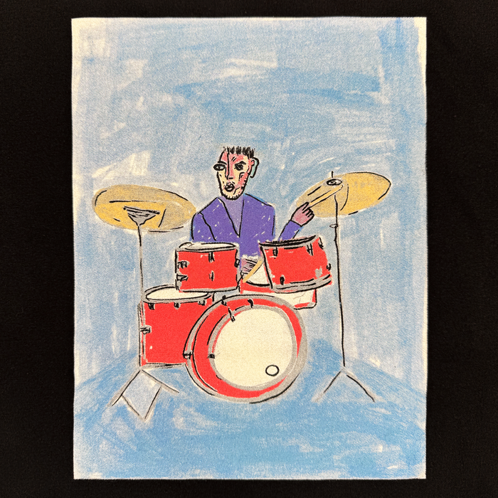 A person with short dark hair plays a red drum set with two cymbals, wearing an Other Drummin’ Blues Tee in purple. Set against a textured light blue background, the abstract illustration features bold outlines and expressive details, capturing the vibrant energy of Oakland jazz art.