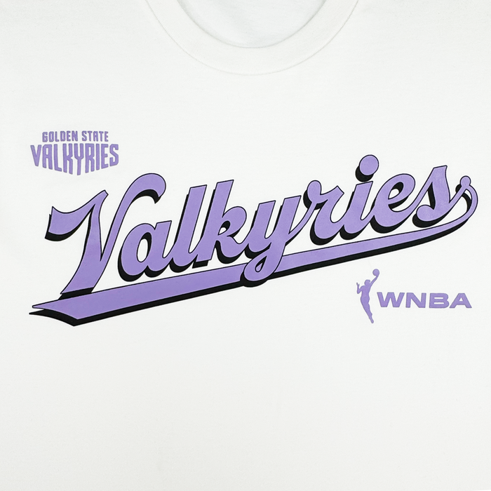 The GSV Golden State Valkyries Retro Script Tee is made from organic cotton and features "Golden State Valkyries" in purple above a large, cursive "Valkyries," accented by a purple WNBA logo and bold underline.