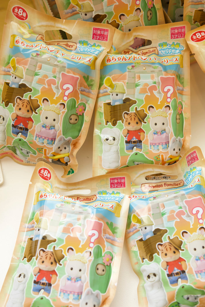 sealed bags fanned around four opened figures