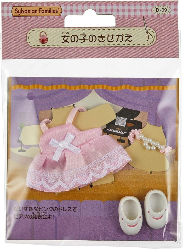 Sylvanian Families packaging with pink dress, shoes, and piano on a checkered background