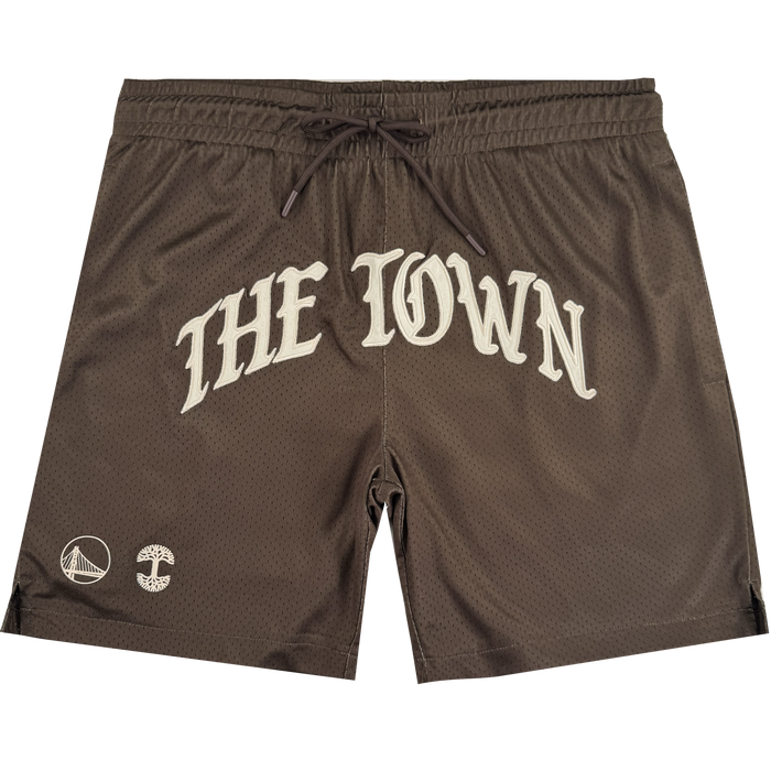 Arched Black-Letter Shorts by Other feature "THE TOWN" in bold white lettering across the front, taking inspiration from the iconic Warriors Town jersey. Near the left leg opening are two distinct logos: the Golden State Warriors bridge logo and a circular emblem. Designed with an elastic waistband and a black drawstring, these shorts are a standout piece from the exclusive Town Collection.