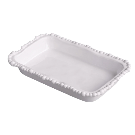 White ceramic dish with decorative edge on a white background