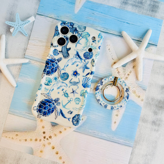 Blue Lagoon nautical watercolor MagSafe phone grip ring with sea turtles, whales, and jellyfish in shades of blue on a white background compatible with iPhone and Samsung