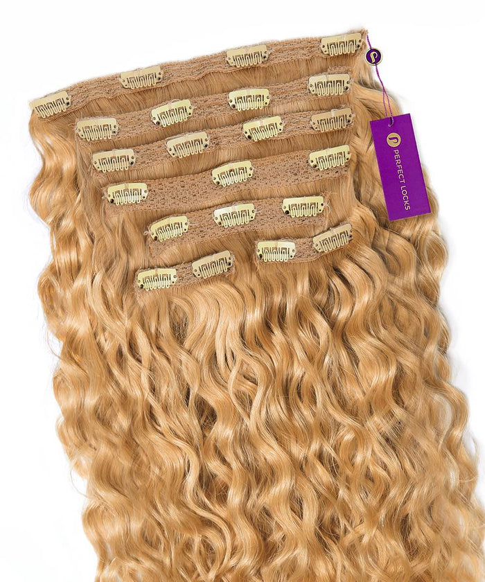 Golden Brown  Curly Classic Clip-In Hair Extensions by Perfect Locks with shiny defined curls and secure clips at the top. A purple "Perfect Locks" tag is attached on one side.#color_honey-blonde-(27)