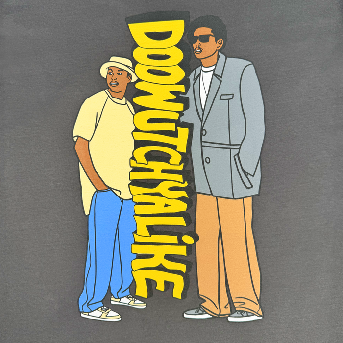 Cartoon of two men—one in a suit and sunglasses, the other rocking a hat, sneakers, and the Doowutchyalike Tee by Other for an authentic 90s hip hop look—stand side by side. Bold yellow “DOOWUTCHYALIKE” runs vertically between them on a gray background.