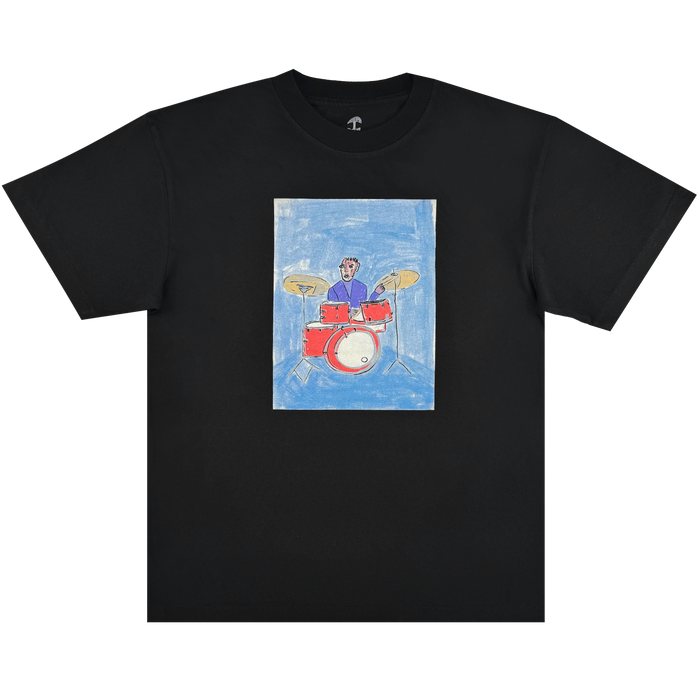 Showcasing a playful Oakland jazz vibe, the Drummin’ Blues Tee by Other features a black base with a centered rectangle displaying a childlike illustration: a smiling drummer in a purple shirt playing a vibrant red drum set against a blue backdrop. This unique design combines an energetic, naive art style with musical flair—making it the perfect choice for those who appreciate artistic expression and jazz history in one standout t-shirt.