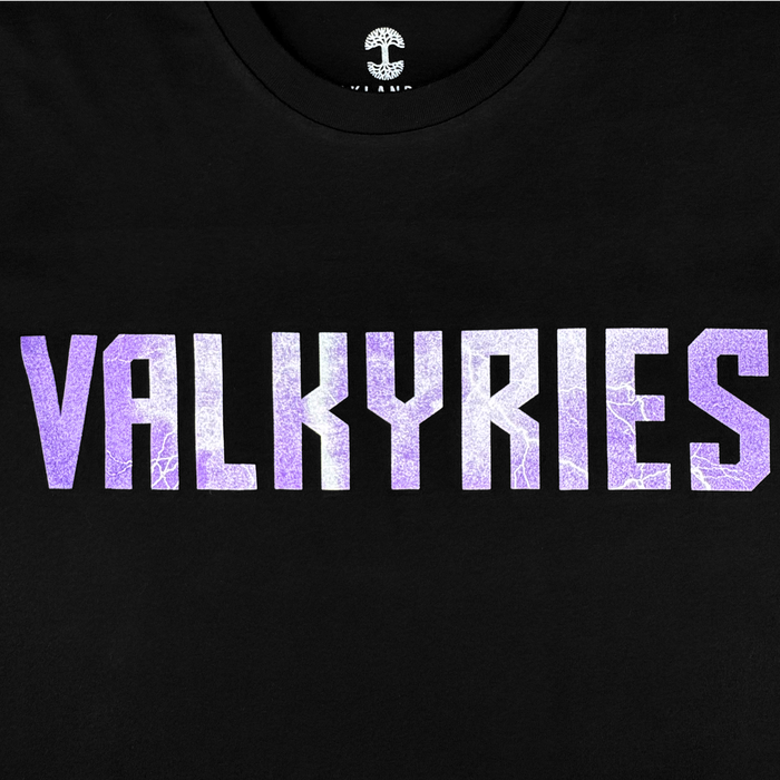 The GSV Golden State Valkyries Violet Lightning LS Tee features "VALKYRIES" in bold, purple-and-white crackled letters on a black long sleeve—ideal for Valkyries fans. Only the upper chest text is visible.