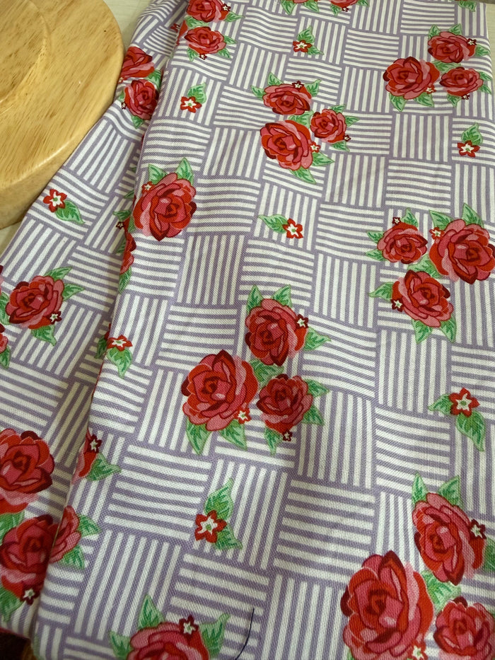 Floral headband on a mannequin head against a plain background