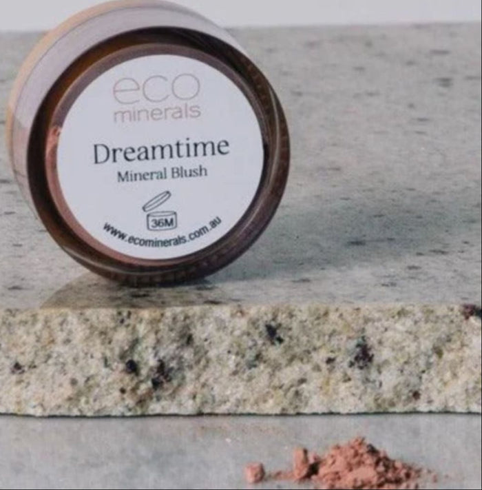 Jar of Eco Minerals Dreamtime Mineral Blush on a stone surface.