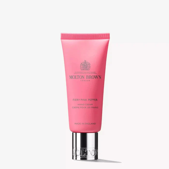 Pink hand cream tube with silver base on a white background