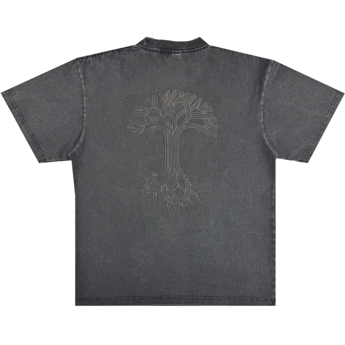 The Oaklandish Classic Logo Tee by Oaklandish is a faded black heavyweight cotton short-sleeve shirt featuring an oversized fit, standard collar with visible stitching, and a large light grey line-art tree design on the back.