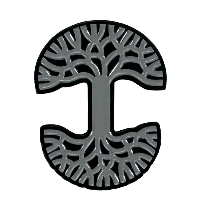 The Oaklandish Logo Enamel Pin by Oaklandish is a circular, grey enamel pin with a capital “I” at the center, tree branches above, roots below, and a black outline on a white background.