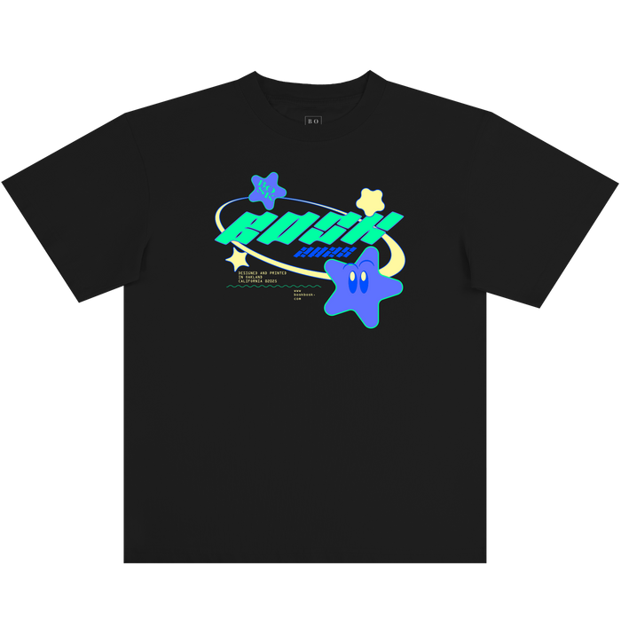 Introducing the Star Power Tee by Other—a black, classic fit t-shirt crafted from 100% heavy-weight cotton. This tee features bold blue and green “ROCKET PLANET” text accented with a playful blue star cartoon character, smaller stars, and a planetary ring. Additional small white text and graphics appear just below the main design at the front center for extra detail.
