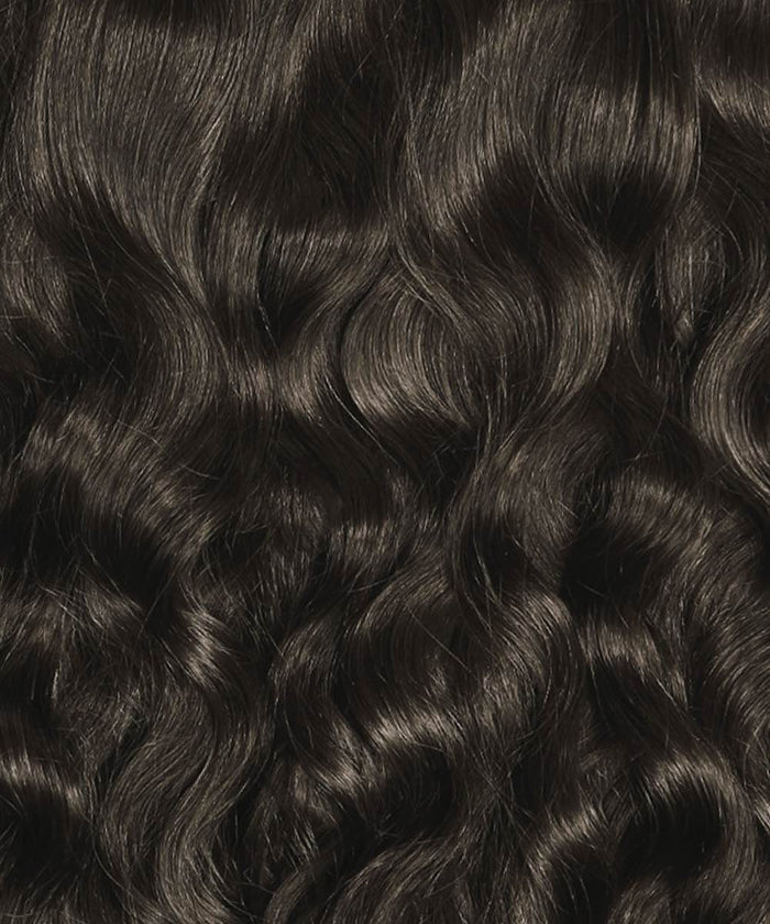 Perfect Locks Wavy Classic Clip-In Hair Extensions in Natural Black , with well-defined, glossy waves for a shiny, healthy look.#color_natural-black-(1B)