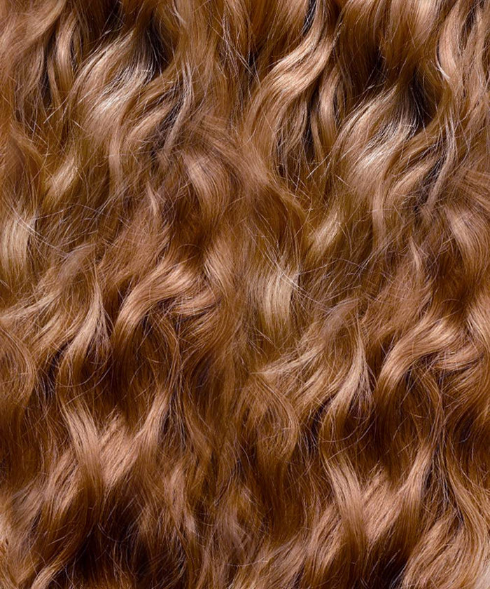 Close-up of wavy, golden brown  hair with soft curls and natural shine, ideal for blending with clip-in extensions seamlessly.#color_golden-brown-(6)